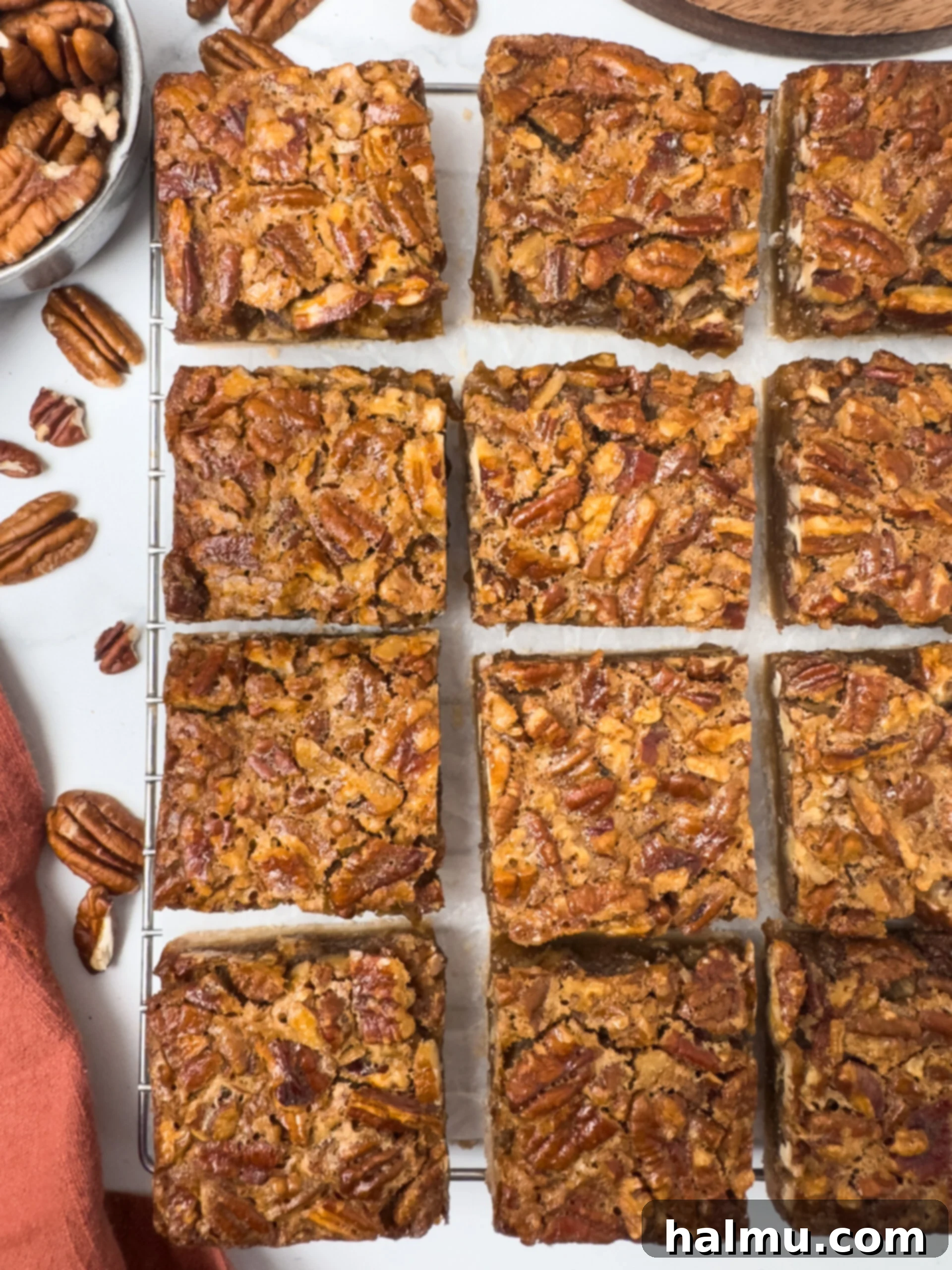 A serving of a Pecan Pie Bar on a white plate, showing the layers of crust and filling.