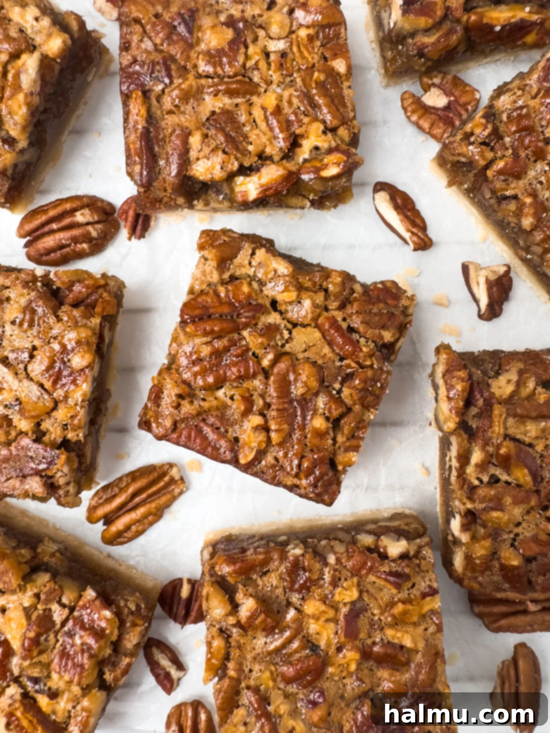 Close-up of golden brown Pecan Pie Bars, highlighting the gooey pecan filling.