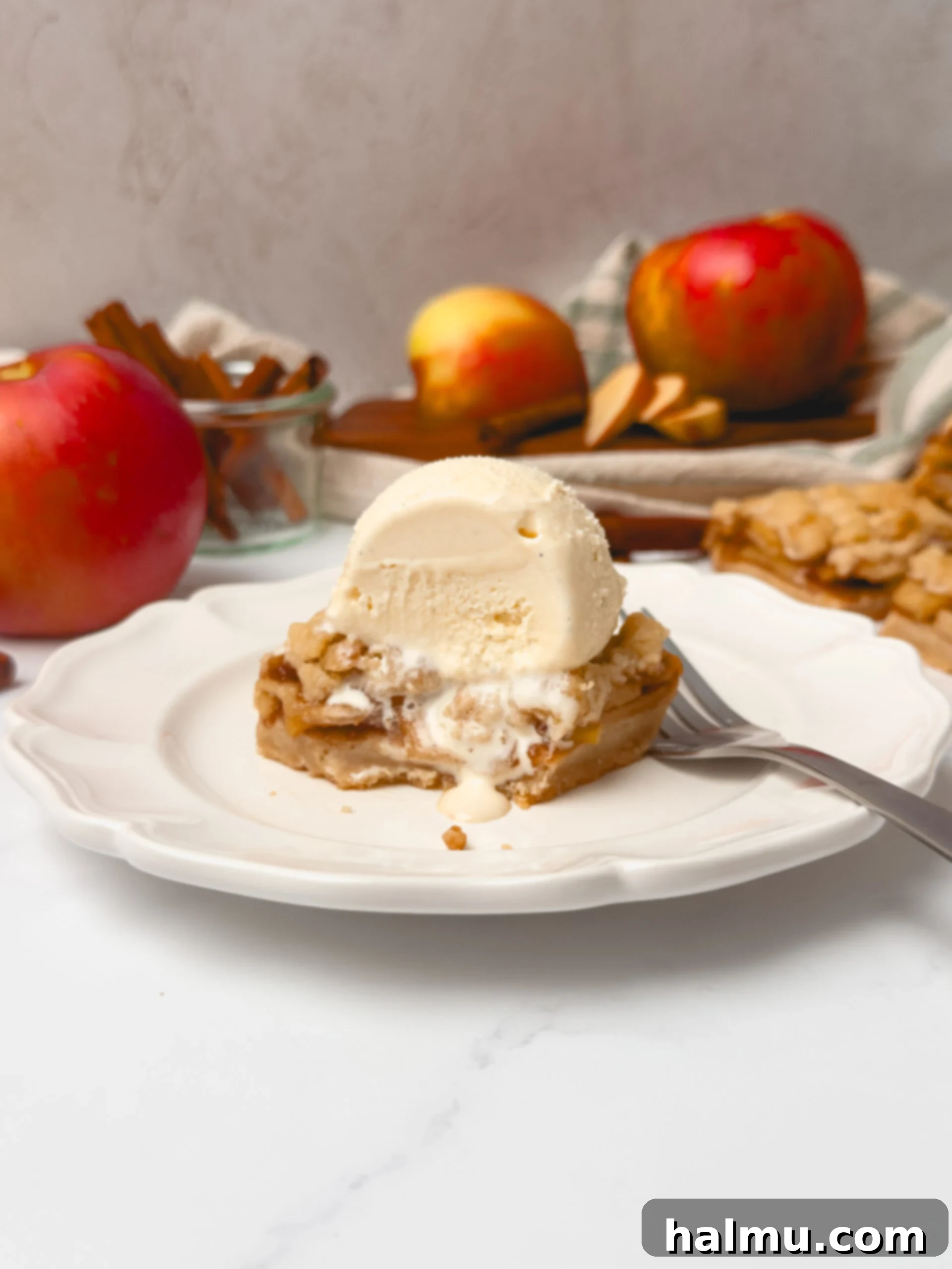 Close-up of baked apple pie bars with a dusting of powdered sugar