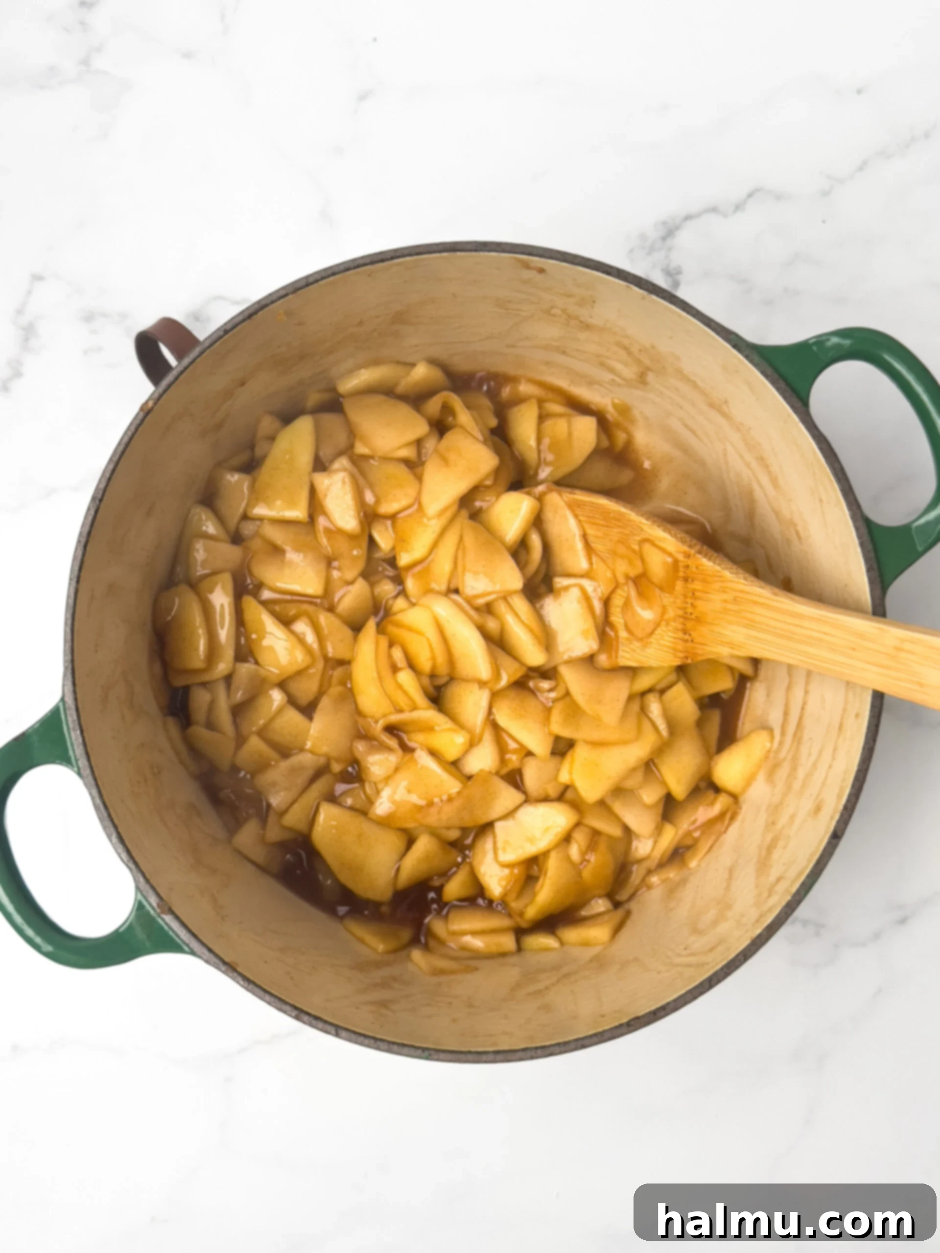 The shortbread crust baking in a square pan, turning golden brown